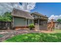 Large backyard showcasing a screened porch, brick patio, and mature trees at 1885 Vintage Dr, Snellville, GA 30078