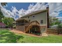 Expansive backyard featuring a screened porch, wooden deck, and lush green lawn at 1885 Vintage Dr, Snellville, GA 30078