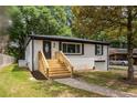Recently renovated home with new stairs, brick exterior, and well-manicured lawn at 208 Silver Springs Sw Cir, Atlanta, GA 30310