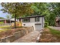 A lovely brick home featuring a one car garage and retaining wall at 208 Silver Springs Sw Cir, Atlanta, GA 30310