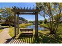 Bench swing overlooking a pond with fountain at 2103 Drogheda Ln, Marietta, GA 30066