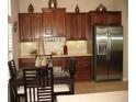 Kitchen with cherry wood cabinets, granite countertops, and stainless steel appliances and breakfast area at 1213 Dawnview Dr, Locust Grove, GA 30248