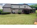 Backyard featuring a spacious lawn and covered patio area perfect for entertaining at 5403 Timber Wild Ln, Buford, GA 30518