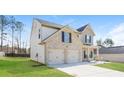 Angle side view of the house showcasing the garage, lawn, and architectural details at 89 Citadel Dr, Hampton, GA 30228