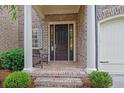 Inviting front porch with brick steps, seating, and pillars at 125 Windy Pines Pass, Roswell, GA 30075