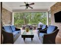 Relaxing screened-in patio with comfortable seating and an outdoor dining area at 125 Windy Pines Pass, Roswell, GA 30075