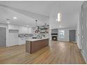 Open-concept floorplan showcasing the kitchen island, a fireplace, and hardwood floors at 4336 Southvale Dr, Decatur, GA 30034