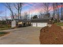 Charming home with a two-car garage and inviting front porch, nestled on a beautifully landscaped lot at 6265 Reives Rd, Cumming, GA 30041