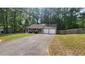 Nice single-Gathering home featuring a long driveway, a two-car garage, and a lush, green lawn at 2849 Appling Way, Kennesaw, GA 30152