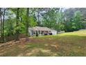 Well-maintained home featuring a manicured lawn, fenced yard, and mature trees providing ample shade at 2849 Appling Way, Kennesaw, GA 30152