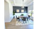 Elegant dining room featuring modern lighting, wainscotting, designer paint, and a view of the outdoors at 261 Arborview Dr, Mcdonough, GA 30252