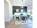 Stylish dining area with modern decor, including a bold accent wall and decorative lighting at 261 Arborview Dr, Mcdonough, GA 30252