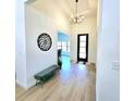 Inviting entryway features a modern light fixture, bench seat, and decorative wall art at 261 Arborview Dr, Mcdonough, GA 30252