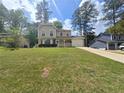Beautiful two-story home with an attached garage, complemented by a lush green lawn and a sunny sky at 5229 Mountain Village Ct, Stone Mountain, GA 30083