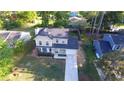 Charming two-story home with a well-manicured front yard and a long driveway leading to an attached garage at 5229 Mountain Village Ct, Stone Mountain, GA 30083