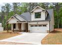 Charming exterior elevation featuring white siding, stone accents, and a welcoming front porch at 110 Doris Path, Dallas, GA 30157