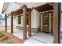 Inviting front porch with wooden beams, stone accents, and stylish hanging lanterns at 110 Doris Path, Dallas, GA 30157