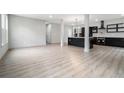 Bright, open-concept living area with modern wood floors and a glimpse into the sleek, black kitchen at 3139 Alston Dr, Decatur, GA 30032