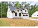Beautiful home with a white facade, a well-manicured lawn and professional landscaping at 130 Doris Path, Dallas, GA 30157