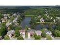 Aerial view of a community with homes surrounding a serene lake with wooded scenery at 2436 Camden Lake Nw Vw, Acworth, GA 30101