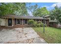Charming brick home with a well-maintained front yard and classic black shutters at 3743 Tree Bark Trl, Decatur, GA 30034