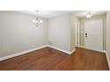 This dining room includes hardwood flooring and a designer chandelier at 7104 Santa Fe Pkwy, Atlanta, GA 30350