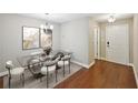 This dining room includes hardwood flooring and a designer chandelier at 7104 Santa Fe Pkwy, Atlanta, GA 30350
