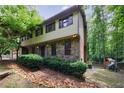Charming two-story home featuring stone accents, a brick chimney, and a spacious yard at 10565 Shallowford Rd, Roswell, GA 30075