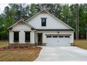 Charming white exterior with stone accents and a two-car garage at 150 Doris Path, Dallas, GA 30157