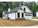 Beautiful white home with a well-manicured lawn and attached garage at 150 Doris Path, Dallas, GA 30157