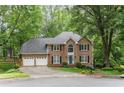 Elegant two-story brick home featuring a manicured lawn, black shutters and a two car garage at 3157 Sawyer Ne Ct, Marietta, GA 30066