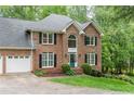 Elegant two-story brick home featuring a manicured lawn, black shutters and a two car garage at 3157 Sawyer Ne Ct, Marietta, GA 30066