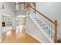 Bright foyer with hardwood floors, staircase, and view into the living room and dining room at 5512 Village Rdg, Fairburn, GA 30213