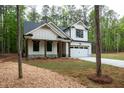 Charming new construction home featuring white siding, dark roof, and a two-car garage at 160 Doris Path, Dallas, GA 30157