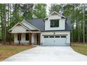 Inviting home with a white exterior, a two-car garage, and a spacious concrete driveway at 160 Doris Path, Dallas, GA 30157