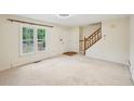 Inviting living room boasting a staircase, large window, and neutral carpeting, ready for your personal touch at 187 Timber Creek Sw Ln, Marietta, GA 30060