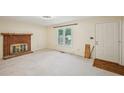 Cozy living room with a brick fireplace, large window and neutral carpet at 187 Timber Creek Sw Ln, Marietta, GA 30060