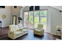 Bright living room with large windows, providing ample natural light, comfortable seating, and views of the outdoors at 3748 Woodrose Ct, Snellville, GA 30039