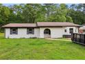 Quaint one-story home with a white brick facade and a spacious front yard ready for landscaping at 2744 Preston Dr, Decatur, GA 30034