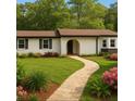 Beautifully landscaped home with stone walkway, lush lawn, and well-maintained garden beds at 2744 Preston Dr, Decatur, GA 30034