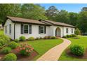 Inviting single-story house with a manicured lawn, brick pathway, and fresh landscaping at 2744 Preston Dr, Decatur, GA 30034
