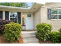 Charming brick home featuring a well-manicured front yard and inviting front door at 299 Stockwood Dr, Woodstock, GA 30188