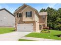 Inviting two-story home with brick and siding, a two-car garage, a well-manicured lawn, and colorful flower beds at 3567 Sycamore Bnd, Decatur, GA 30034
