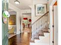 Welcoming foyer featuring hardwood floors, staircase with iron spindles, and a view into the living spaces at 3567 Sycamore Bnd, Decatur, GA 30034