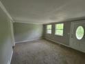 Spacious carpeted living room featuring neutral walls, front door and natural light at 4063 Feather Dr, Douglasville, GA 30135