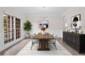 Bright dining room features modern chandelier, natural light, and access to outdoor views at 2111 Fernbank Way, Dacula, GA 30019