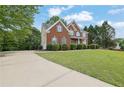 Classic brick home with a long driveway and lush lawn, exuding charm and offering ample outdoor space at 2111 Fernbank Way, Dacula, GA 30019