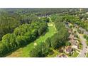 Aerial view of a neighborhood featuring a golf course surrounded by lush trees and luxury homes at 249 Thorncliff Lndg, Acworth, GA 30101