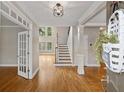 Grand foyer with hardwood floors, staircase, open layout and lots of natural light from the windows at 249 Thorncliff Lndg, Acworth, GA 30101