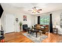 Inviting living room with hardwood floors, a comfortable sofa, and large windows for natural light at 1418 Foxhall Se Ln # 18, Atlanta, GA 30316